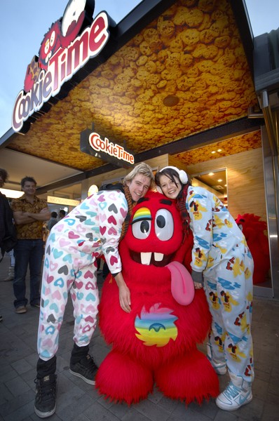 Josh Baldey (L) and Alana Potts (R) celebrate their year's worth of free cookies with the Cookie Muncher